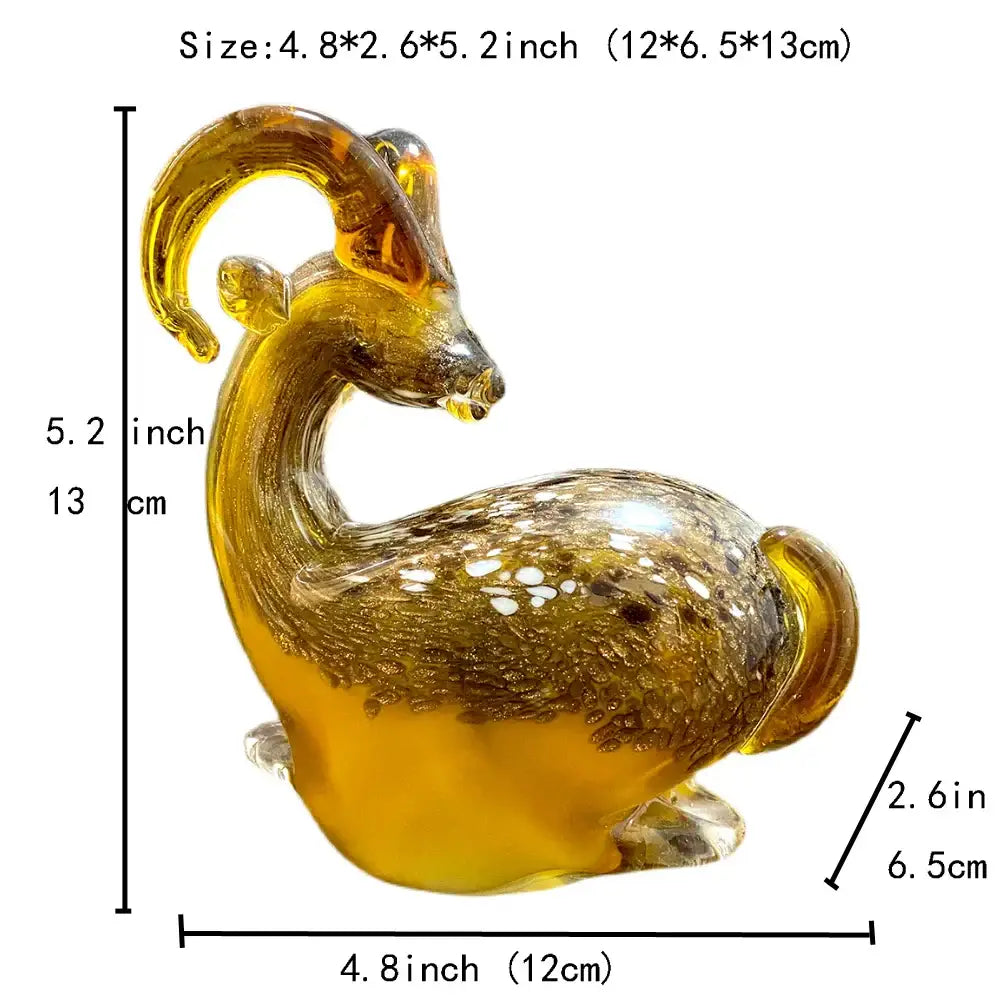 A translucent amber glass sitting ram figurine with curved horns and speckled detailing for decorative use