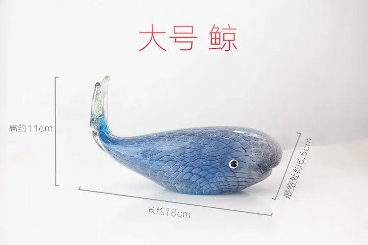 A translucent blue glass whale figurine with textured scales and a black eye for living room glass decor