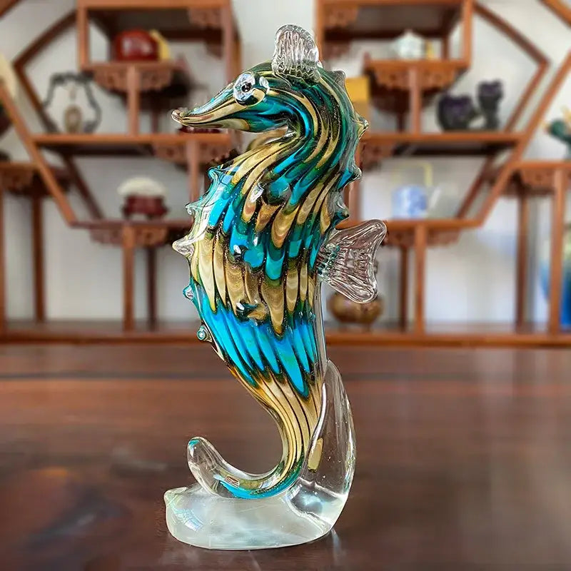 A vibrant hand blown glass sika deer figurine with turquoise and gold patterns for living room decor