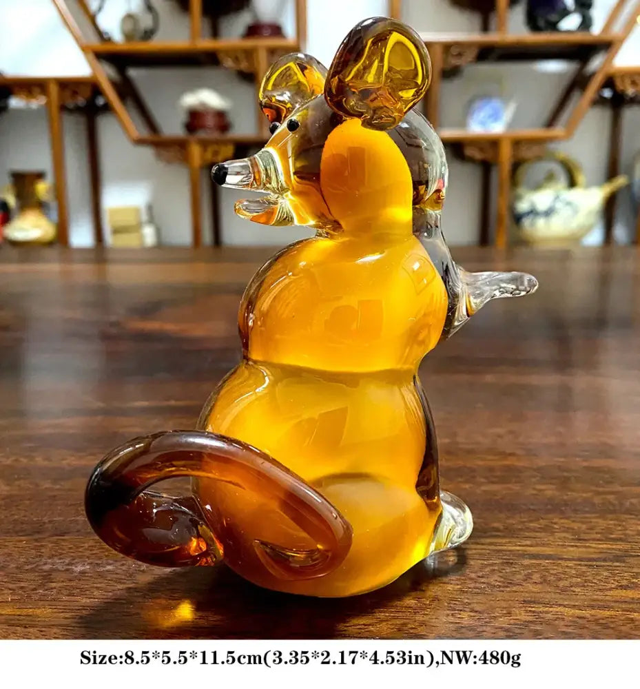 A translucent amber glass mouse figurine with a glossy finish as a decorative sika deer figurine for living room decor