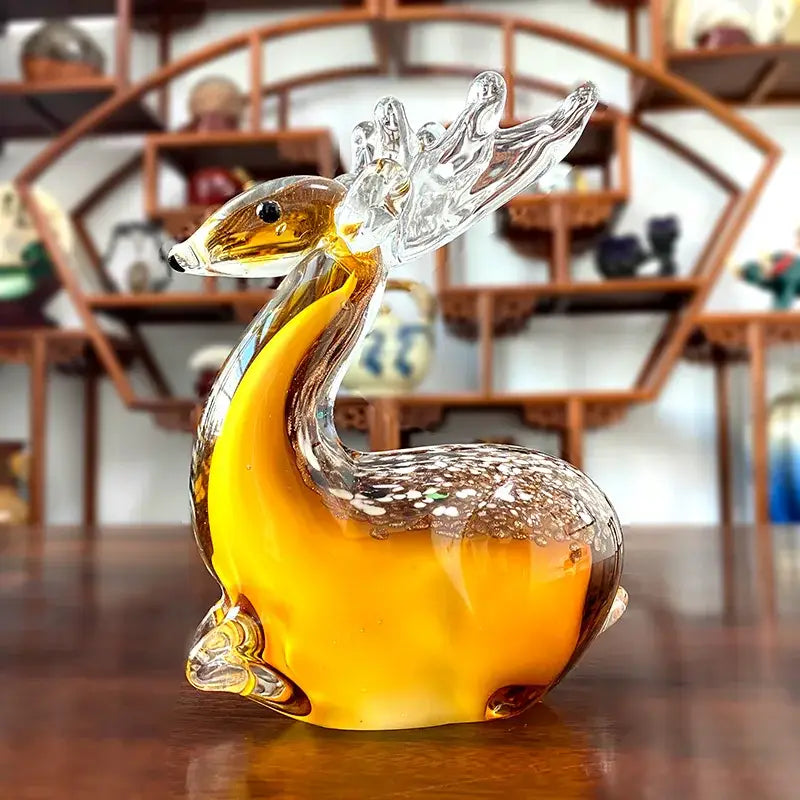 Handmade translucent amber glass sika deer figurine with clear antlers and speckled brown markings for living room decor