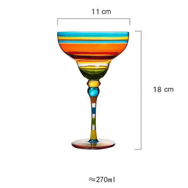 A decorbites handmade colorful margarita-style glass with vibrant orange yellow green and blue stripes for dining room drinkware