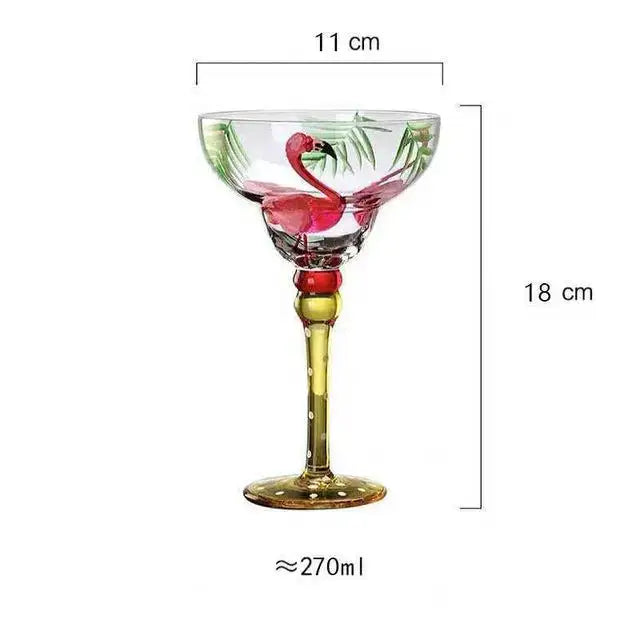 Handmade colorful margarita glass with pink flamingo and green palm leaf design on clear glass with gold stem and base
