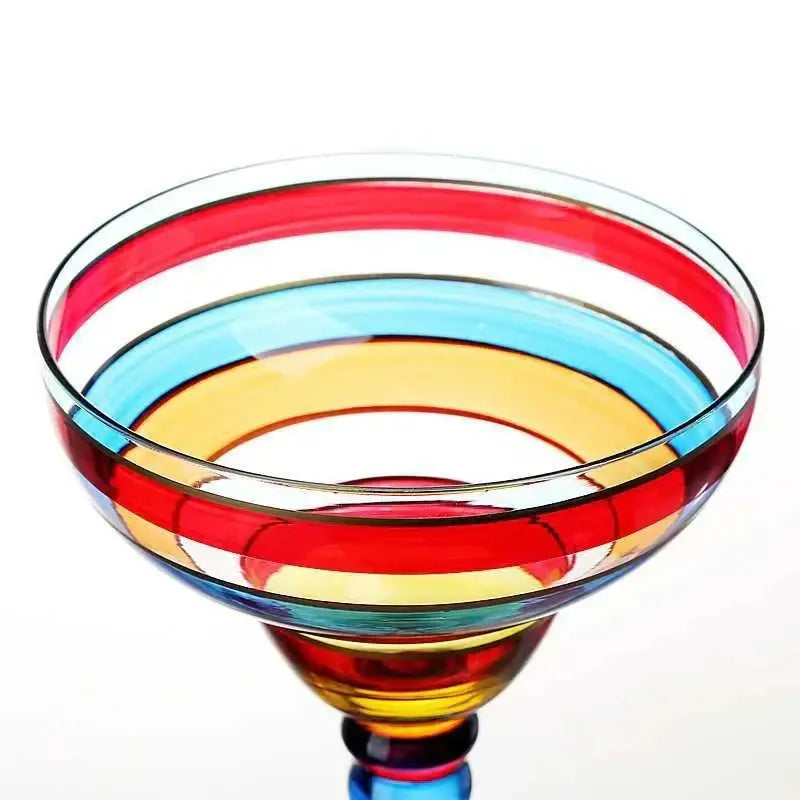 A decorbites handmade colorful margarita glass with red blue yellow and clear concentric stripes for dining room use