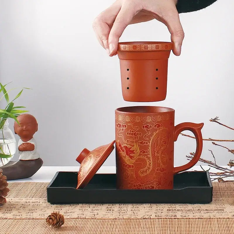 Handmade orange ceramic tea mug with gold dragon design and matching lid infuser purple clay decorbites dragon purple set