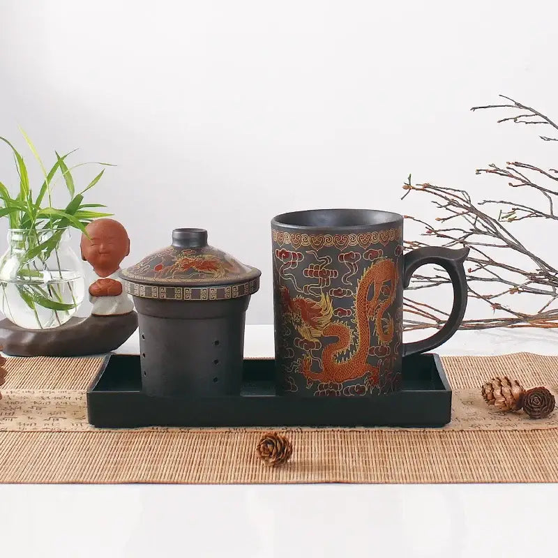 Black ceramic tea mug with intricate orange dragon design made of purple clay from decorbites dragon purple set