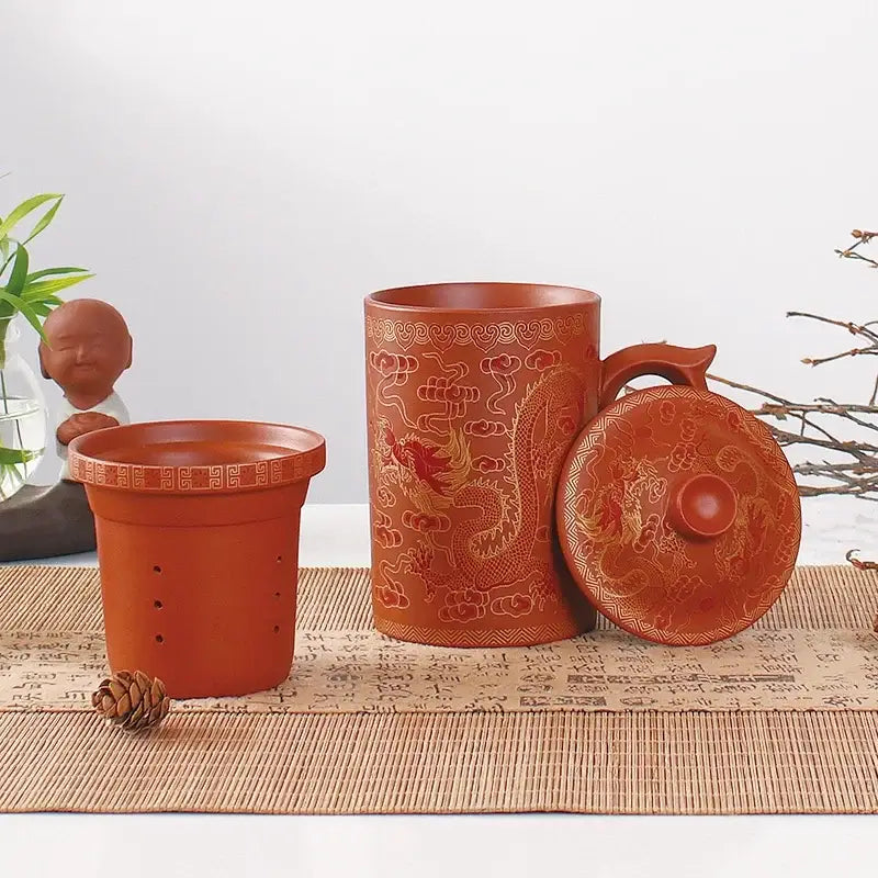 Handmade red clay tea mug with golden dragon and cloud motifs in a decorbites dragon purple clay set for dining room