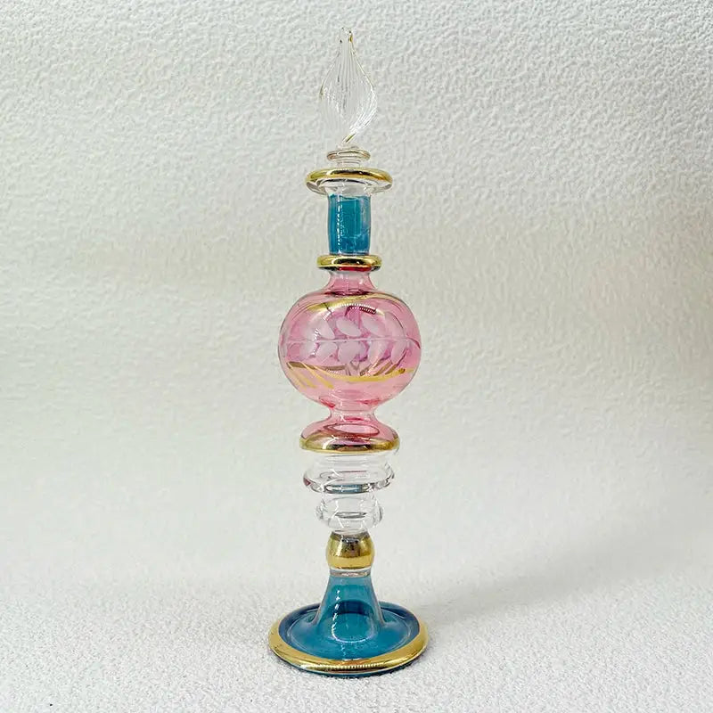 A handmade glass bottle exquisite ornament featuring delicate pink and blue glass with gold floral etchings for decor