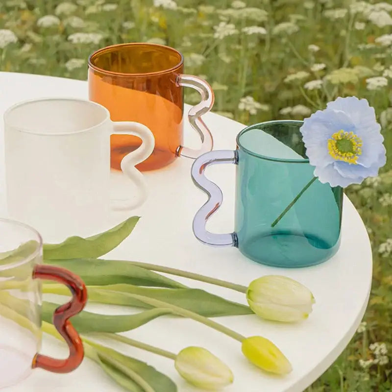 Translucent amber handmade glass mug with wavy sculpted handle from decorbites handmade glass for lavender and green kitchen