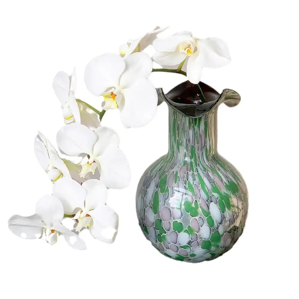 Handmade glass vase emerald and silver swirling decor with translucent green and white mosaic holds white orchids