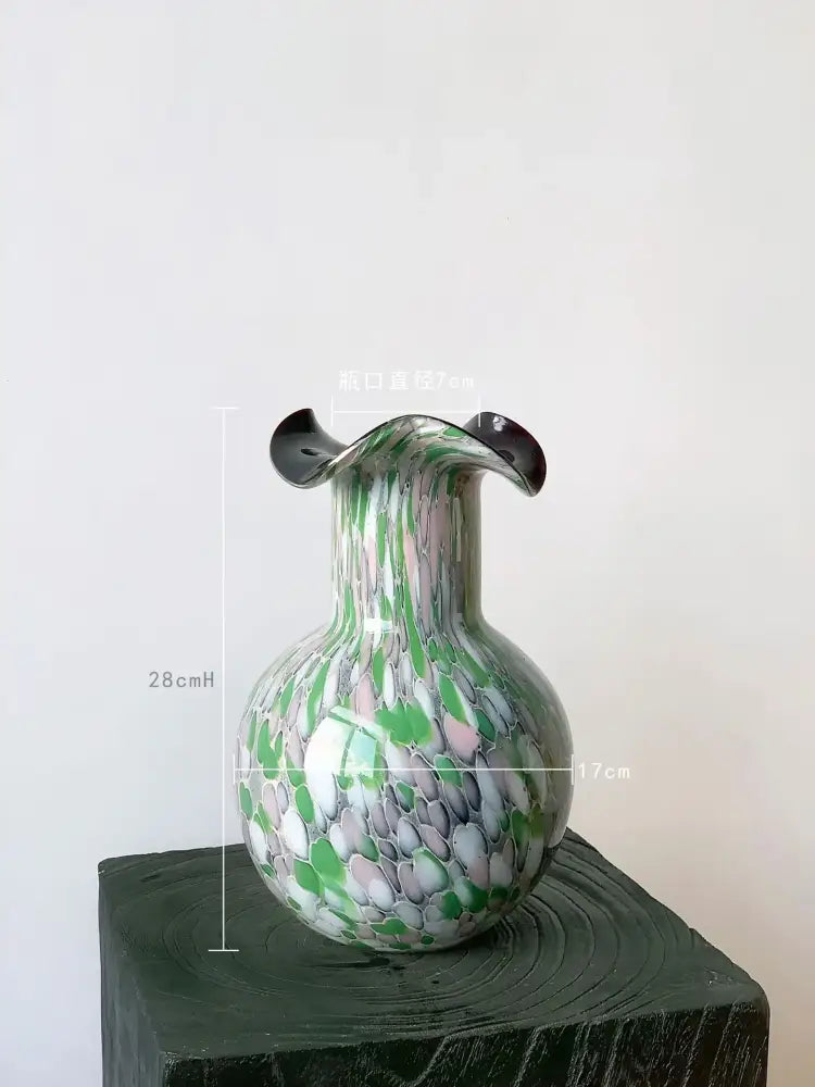 Handmade glass vase with emerald and silver swirling decor featuring a bulbous body and flared black rim by decorbites handmade glass