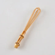 Handmade golden bamboo egg beater flour mixer with decorative segmented handle and fine wire loops for blending