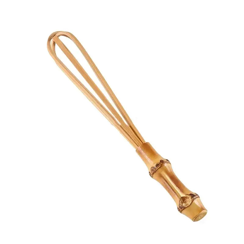 Handmade golden bamboo flour mixer egg beater with a segmented handle and slender curved wires for kitchen use