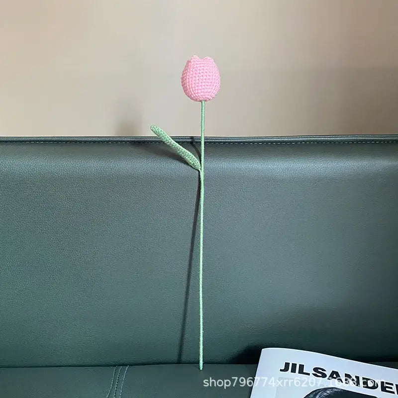 A delicate pink handmade knitted crochet tulip with slender green stem and leaf for bedroom decorbites decor