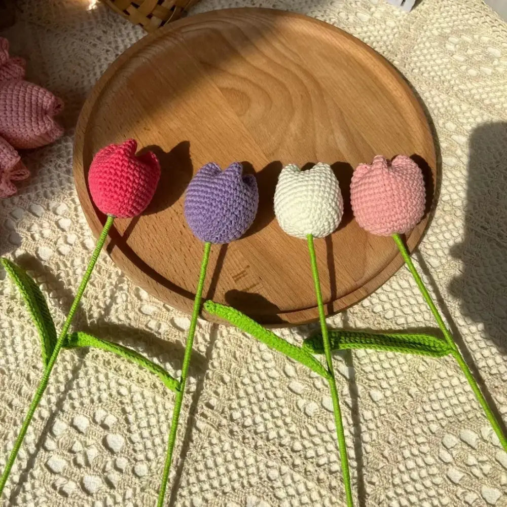 Four decorbites handmade knitted crochet tulips in pink purple white and light pink with green stems for bedroom decor