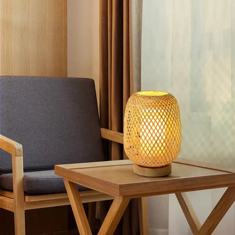 Handmade warm glowing bamboo table lamp with woven lattice design and wooden base for bedroom lighting