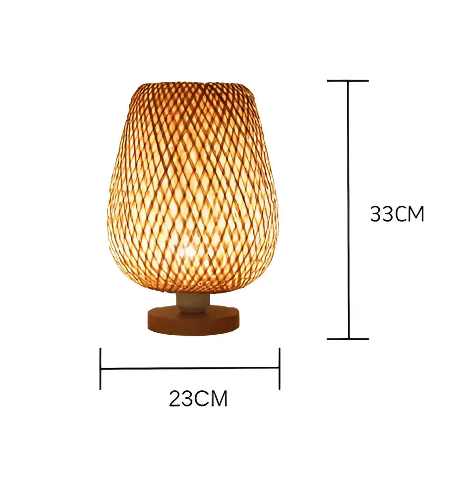 A warm-toned handmade bamboo table lamp with a tapered cylindrical shade and wooden base for bedroom use