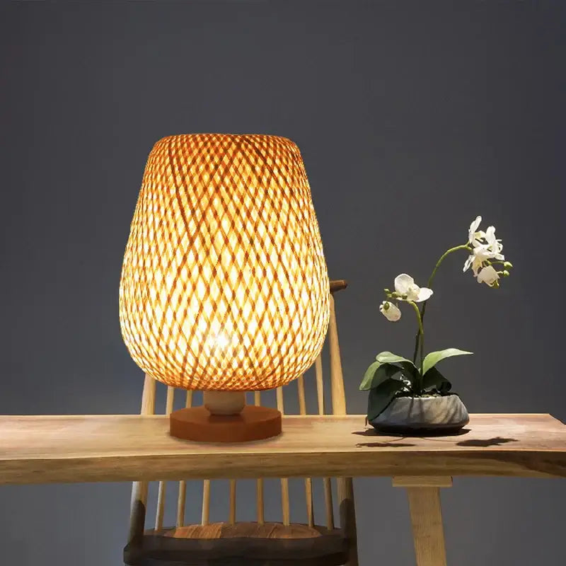 Handmade warm-toned bamboo table lamp with woven lattice shade and natural wood base for bedroom lighting