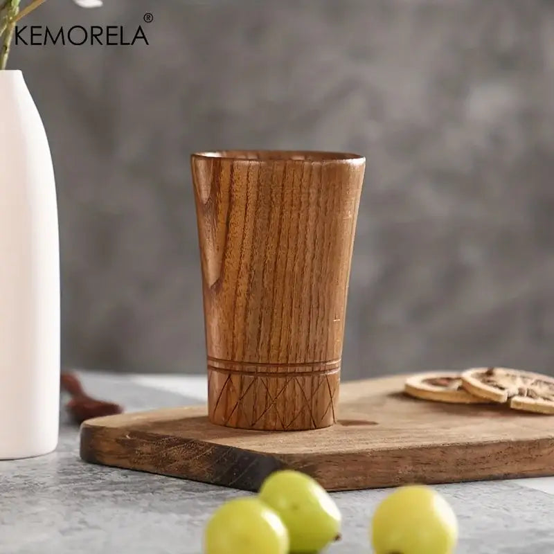 A warm-toned handmade natural wooden tumbler with smooth grain and geometric inlay for natural wooden tea use