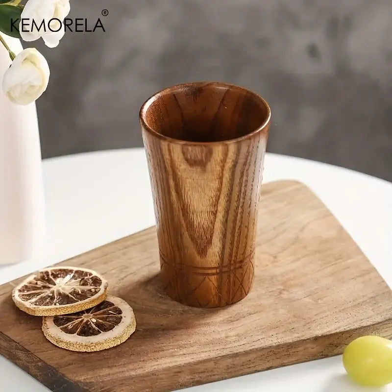 A decorbites handmade natural wooden tea cup with warm brown finish and subtle geometric carvings near the base