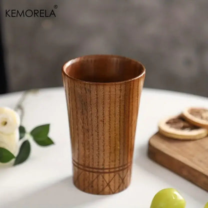 A kemorela handmade natural wooden tea tumbler with warm brown finish and engraved diamond lattice design near base