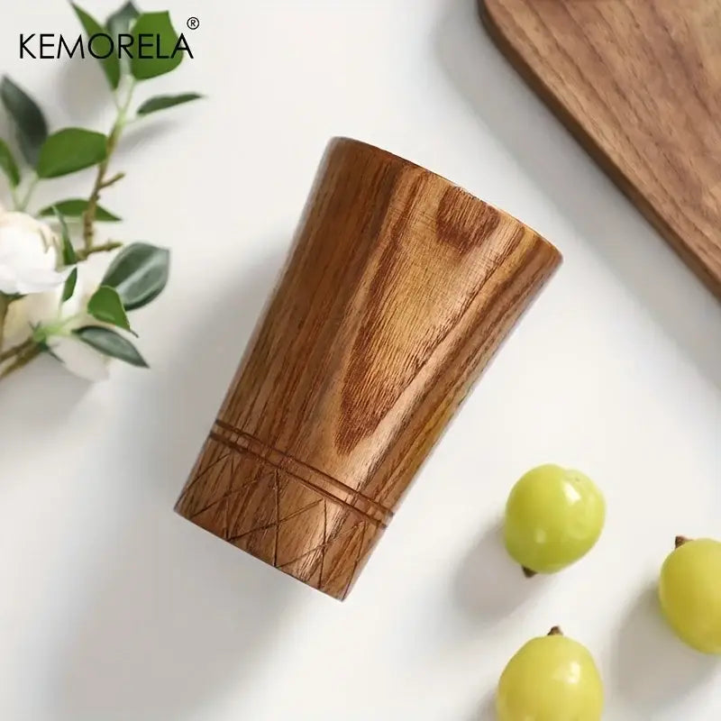 A sleek medium-brown decorbites handmade natural wooden tumbler with geometric carvings ideal for natural wooden tea use