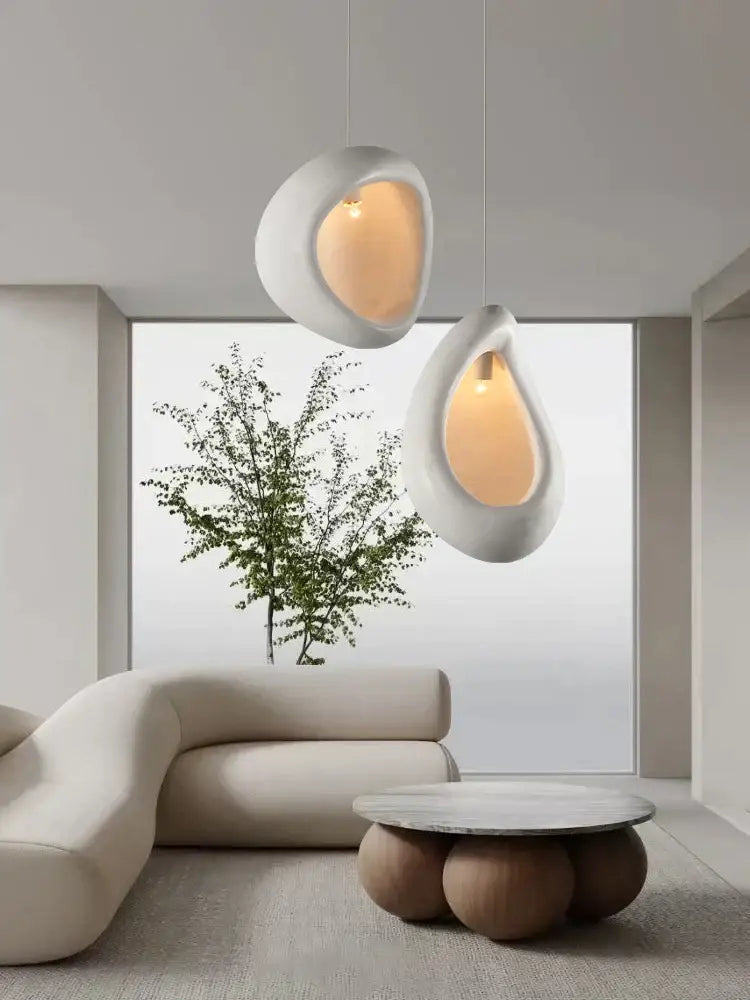 Two smooth white ceramic handmade nordic designer pendant lights with warm amber glow for dining room decorbites chandelier
