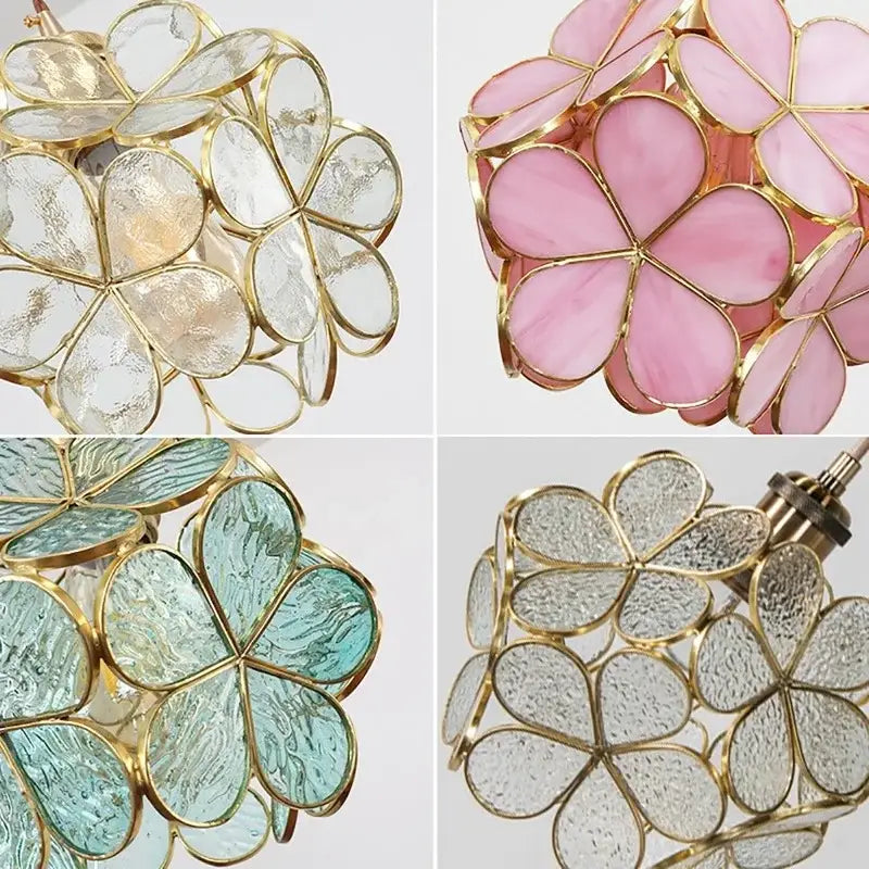 Gold-toned pendant light with glass petal pendant design featuring pink and teal clover-shaped panels suspended by twisted copper cord