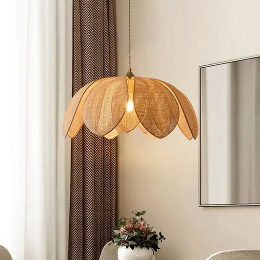 Handmade rattan petal pendant light warm toned with woven natural fiber petals and brass fixture for dining room decorbites