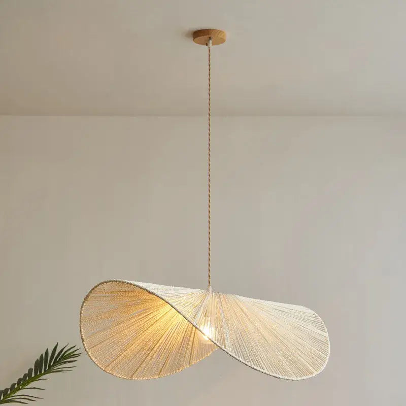 A handmade rattan rope vertigo pendant lamp with twisted natural woven design in warm beige for dining room decorbites