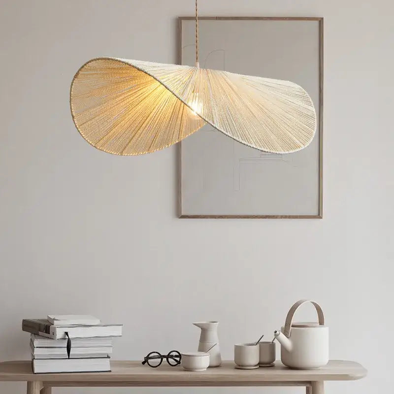 A warm golden-hued pendant lamp with handmade rattan rope and woven leaf design for dining room decorbites handmade rattan