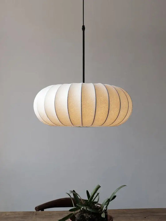A decorbites handmade silk pumpkin pendant light with off-white fabric shade and black rod for dining room decor