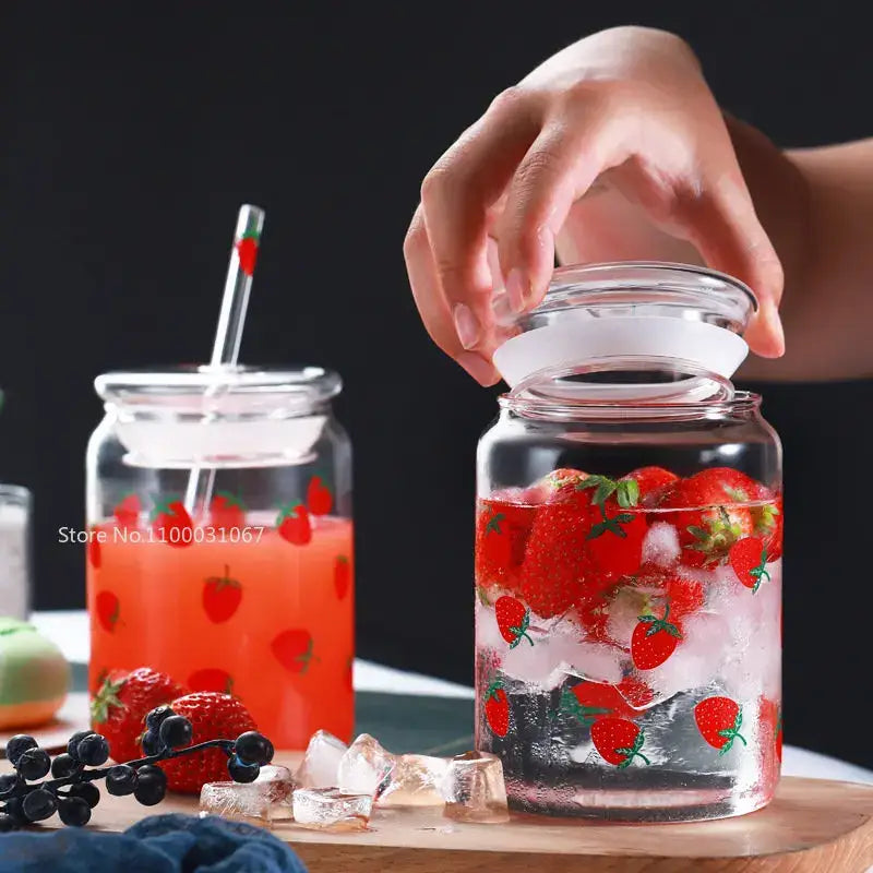 Handmade clear glass cup with strawberry decals white lid filled with ice fresh strawberries from decorbites glass cup set