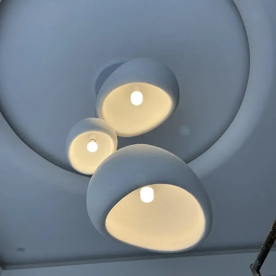 Three matte white handmade wabi sabi chandelier pendant lights with rounded dome shapes for dining room decorbites handmadem wabi