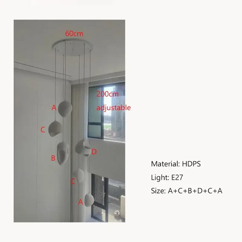 A modern adjustable handmade wabi sabi pendant light with five sculptural stone fixtures in vertical stairs design