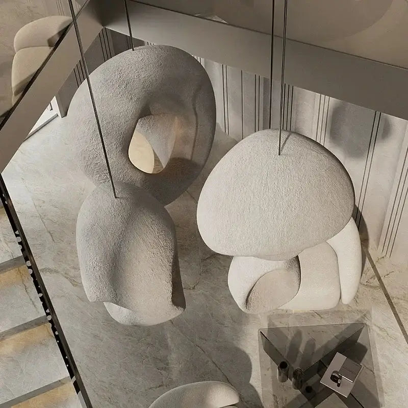 Handmade wabi sabi pendant lights with matte white textured stone and organic cloud like sculptural forms for decorbites
