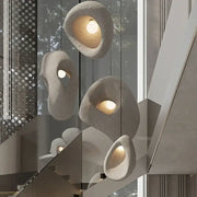 Handmade wabi sabi stone pendant lights with warm glowing interiors and organic irregular shapes for stairs decorbites handmade wabi