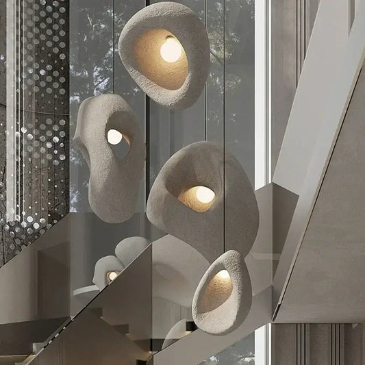Handmade wabi sabi stone pendant lights with warm glowing interiors and organic irregular shapes for stairs decorbites handmade wabi