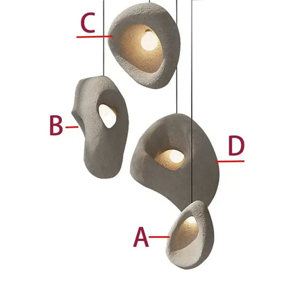 Gray textured stone pendant lights with organic shapes and warm interior lighting handmade wabi sabi decorbites