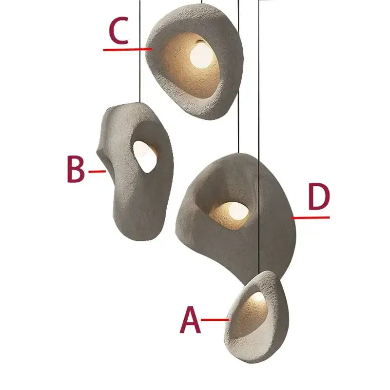Gray textured stone pendant lights with organic shapes and warm interior lighting handmade wabi sabi decorbites