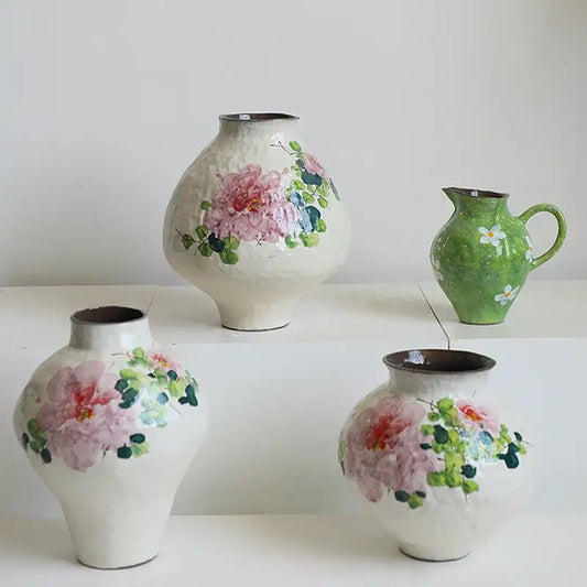 Hand-painted ceramic watercolor flower vase with delicate pink and green floral designs on a textured white surface