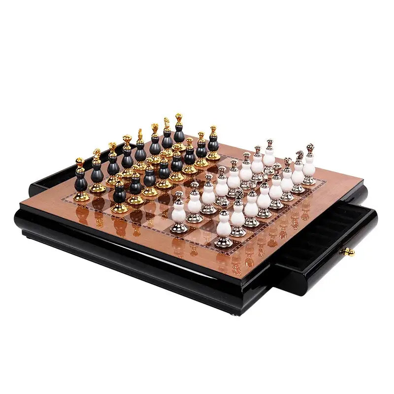 Handmade wooden chess set with black and white gourd-shaped pieces in gold-accented bases in a lacquered box