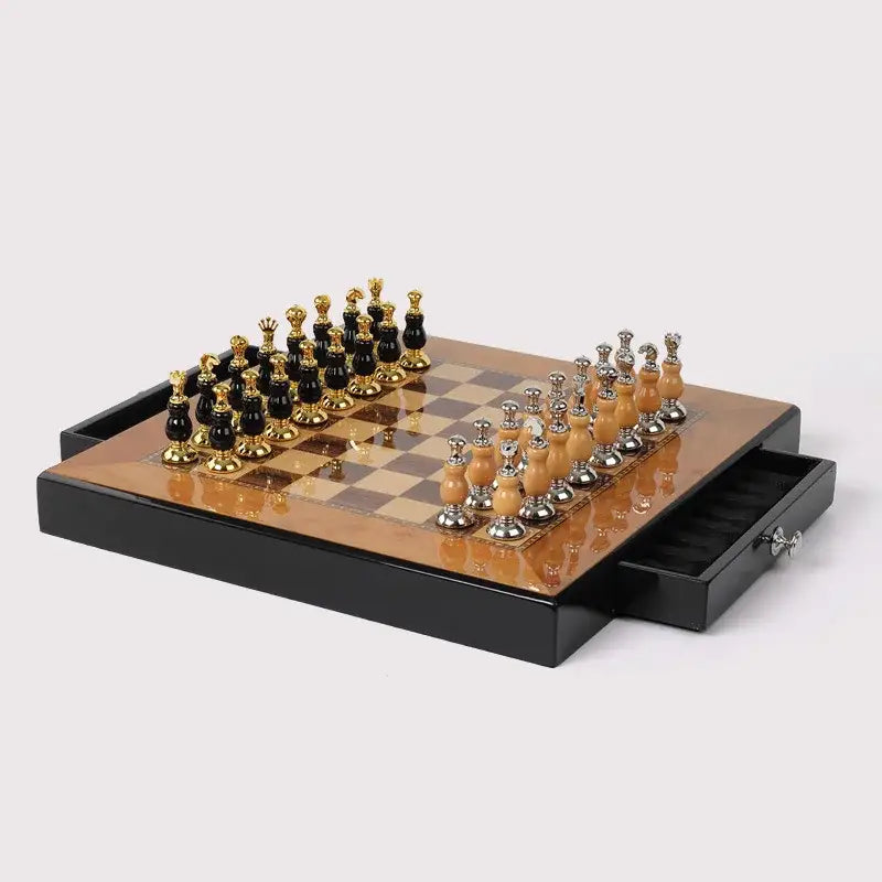 Elegant black and gold handmade wooden chess set with polished pieces on a glossy board in a sleek storage tray
