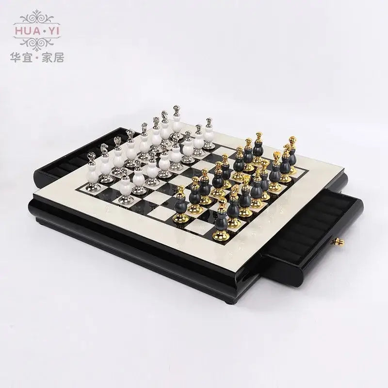 Elegant handmade wooden chess set with black and white marble pieces and gold accents on a glossy wooden board