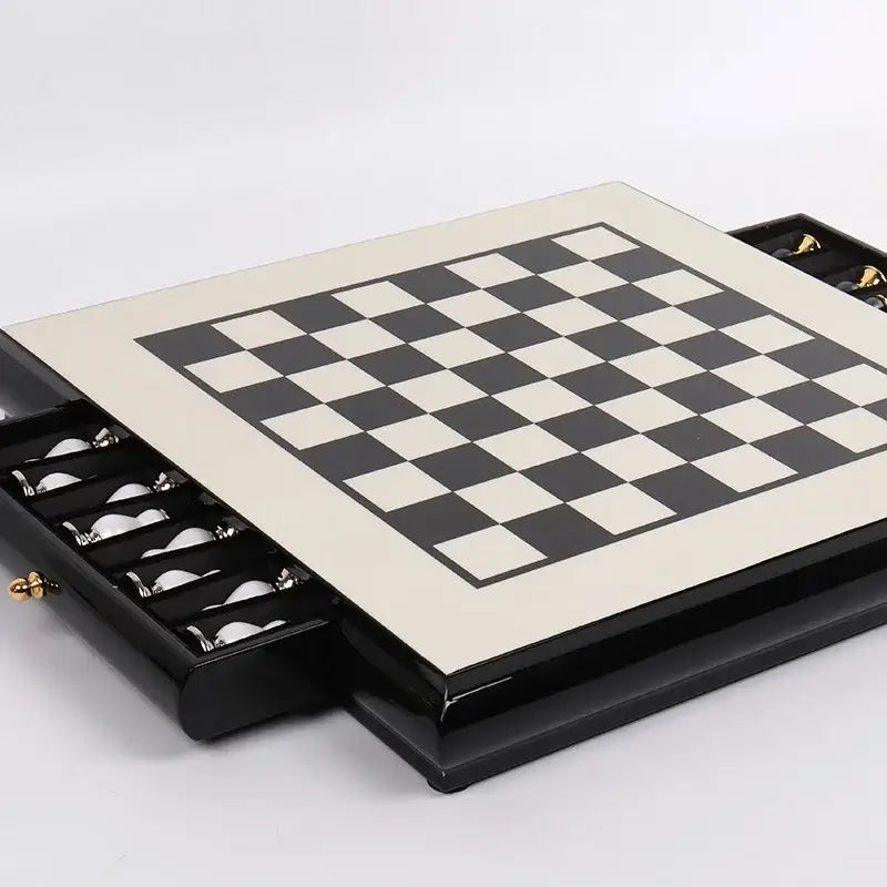 Handmade wooden chess set with black and cream checkered board and integrated storage drawers for pieces