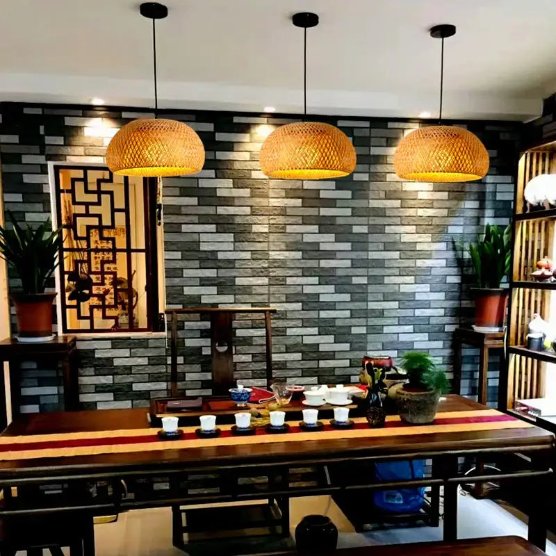 Three warm-toned handwoven rattan pendant lights with a woven design ideal for dining room lighting