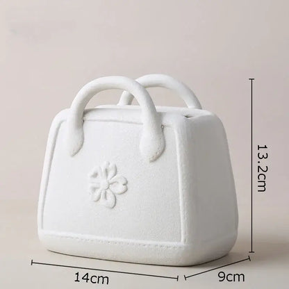 White ceramic ceramic vase shaped like a handbag with floral embossed design and rounded handles decorbites handwoven ceramic vase