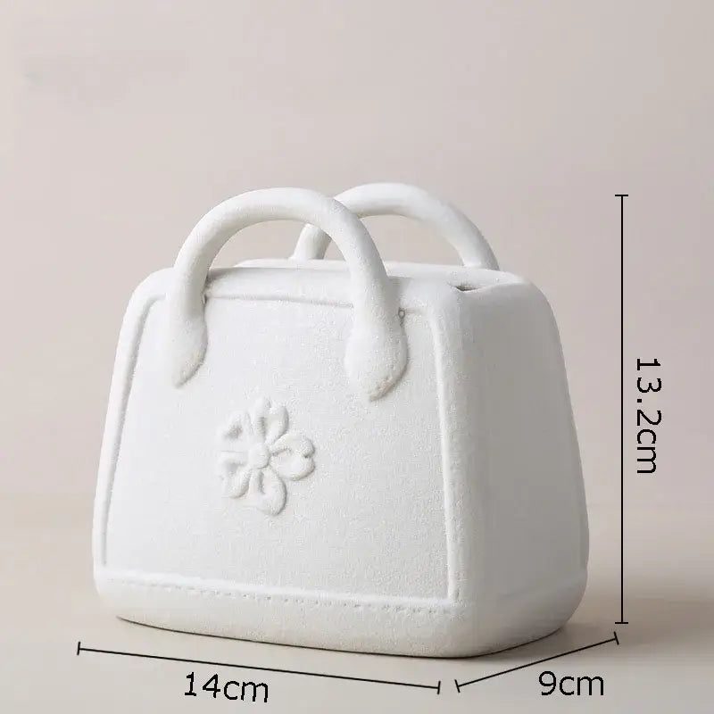 White ceramic ceramic vase shaped like a handbag with floral embossed design and rounded handles decorbites handwoven ceramic vase