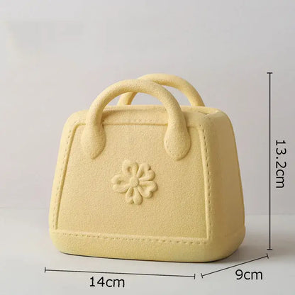 Pale yellow decorbites handwoven ceramic vase shaped like a handbag with embossed floral design for living room decor