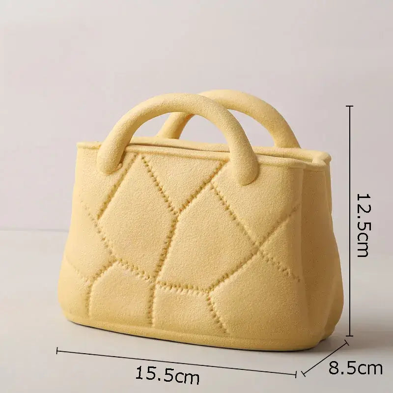 Pale yellow ceramic handbag with quilted diamond pattern and rounded handles as decorbites handwoven ceramic vase planter